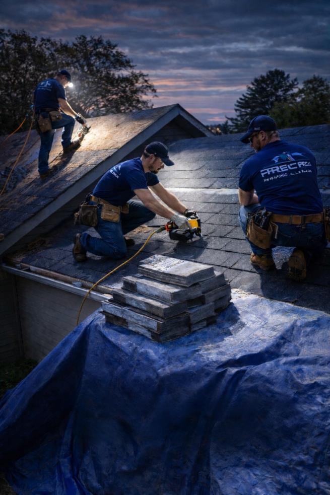 Roofing professionals from Precise Roofing Solutions working on a residential roof, using tools and materials for installation, with a focus on quality service in Spring, TX.